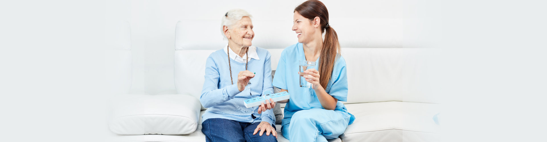 Nurse gives senior woman in nursing home or home medicine